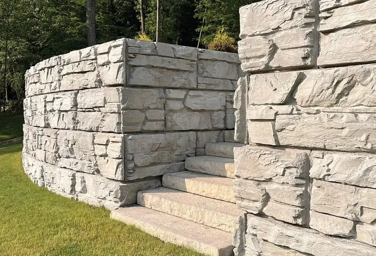 Magnum Stone Large Wall System retaining wall installation with integrated stone steps and natural rock-face texture